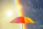 umbrella at a rainy day with rainbow